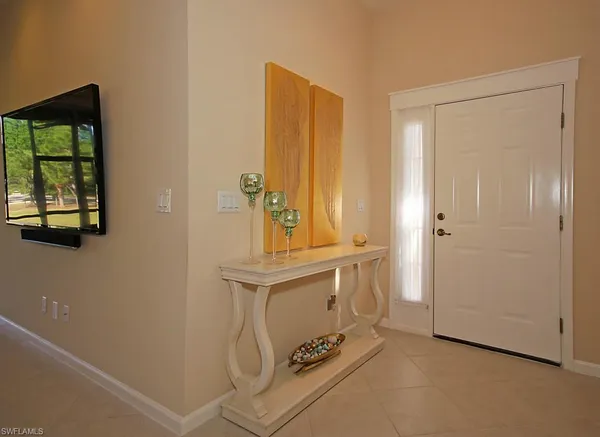 a view of an entryway with table and mirror