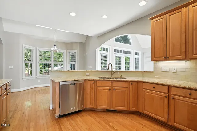 a view of a kitchen counter space with wooden floor and cabinets