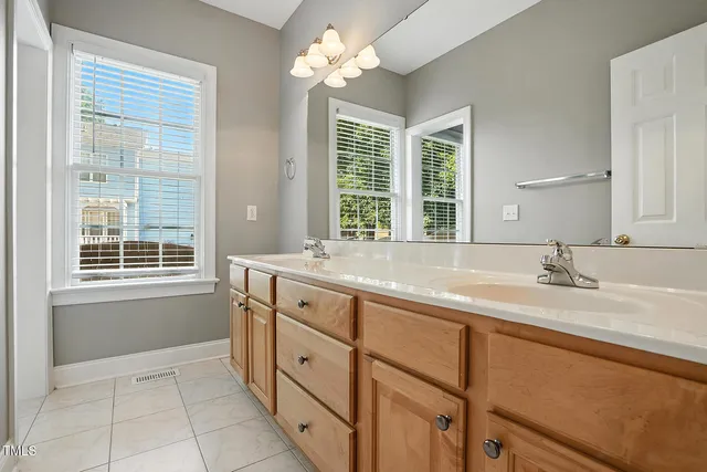 a bathroom with a granite countertop toilet a sink and a bathtub