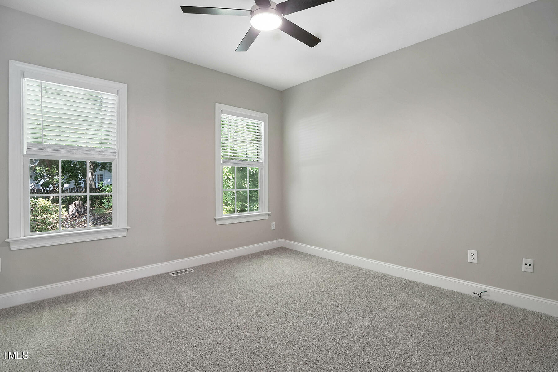 104 Vatersay Drive Apex, NC 27502 - Photo 17 of 30 an empty room with a window and a ceiling fan