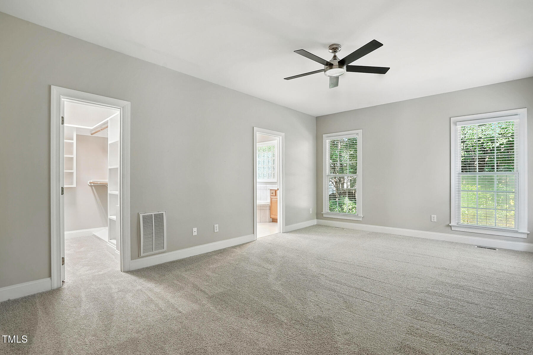 104 Vatersay Drive Apex, NC 27502 - Photo 18 of 30 a view of a livingroom with a ceiling fan & windows