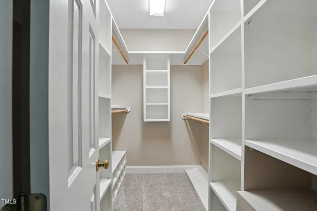 a bathroom with a granite countertop sink a toilet a mirror and shower