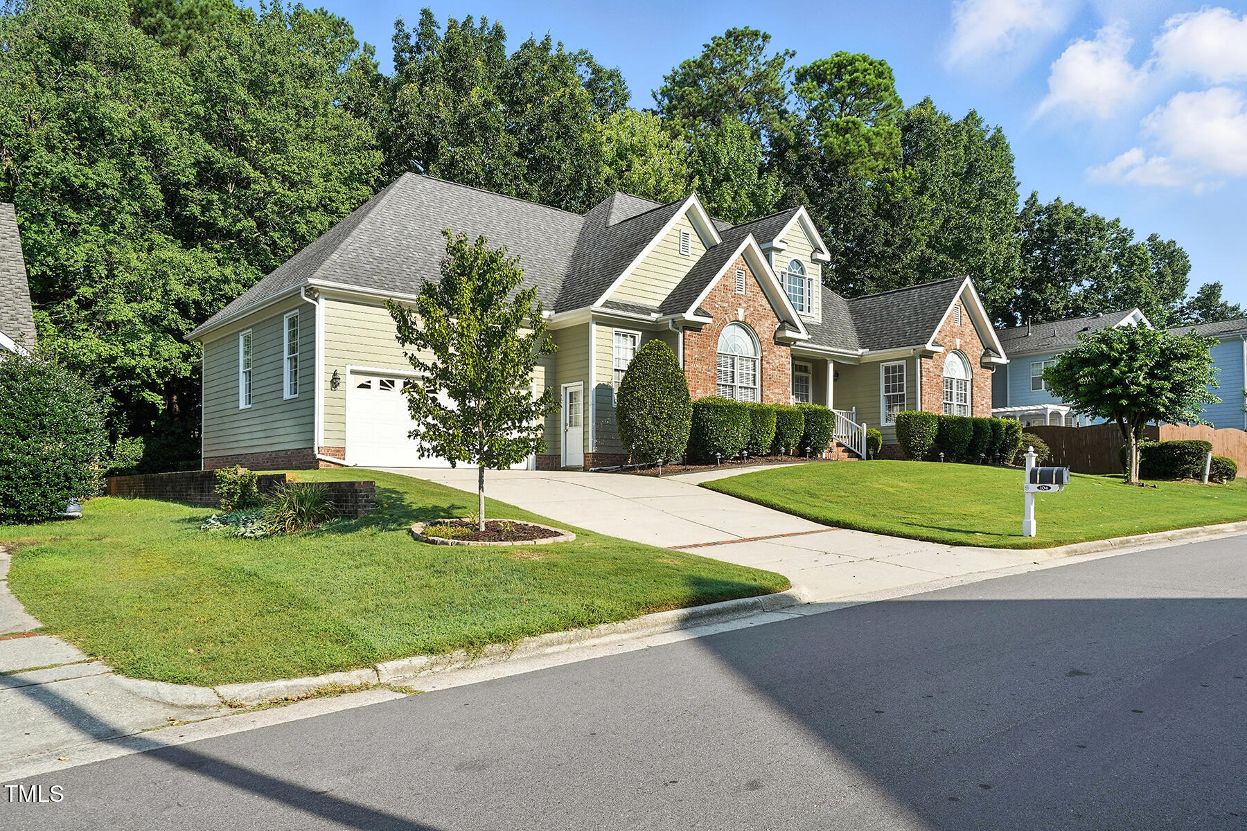 104 Vatersay Drive Apex, NC 27502 - Photo 2 of 30 a white house with a small yard plants and large trees