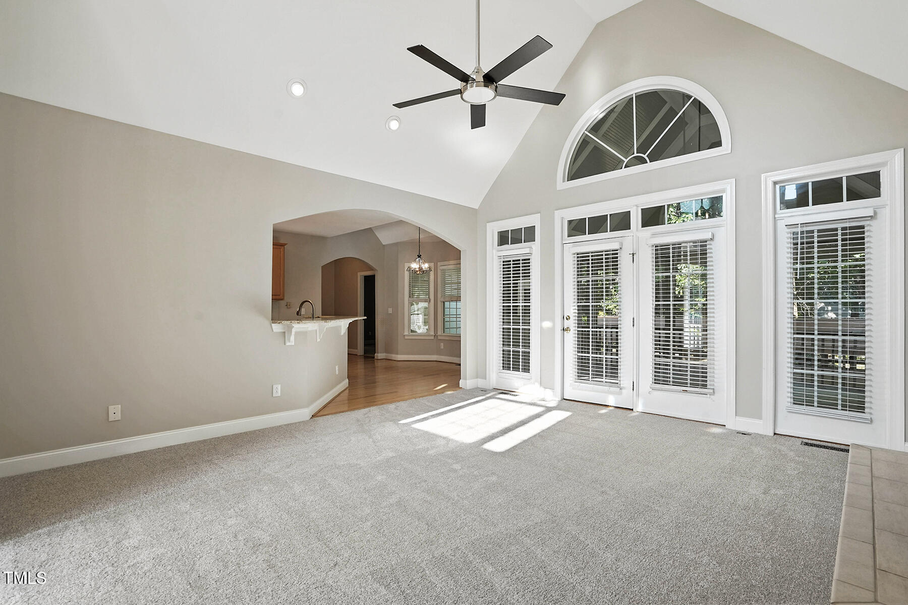 104 Vatersay Drive Apex, NC 27502 - Photo 4 of 30 a view of a livingroom with a ceiling fan and window