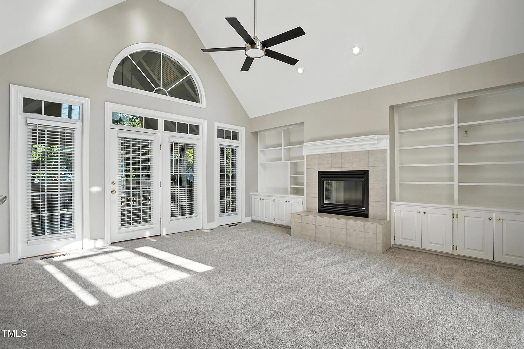 104 Vatersay Drive Apex, NC 27502 - Photo 5 of 30 a view of an empty room with a fireplace and a window