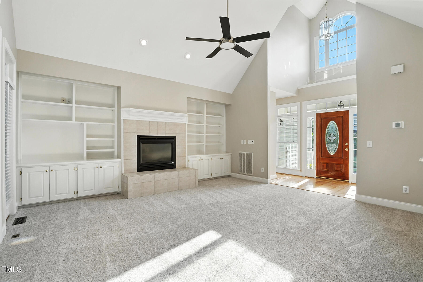 104 Vatersay Drive Apex, NC 27502 - Photo 6 of 30 an empty room with windows and fireplace