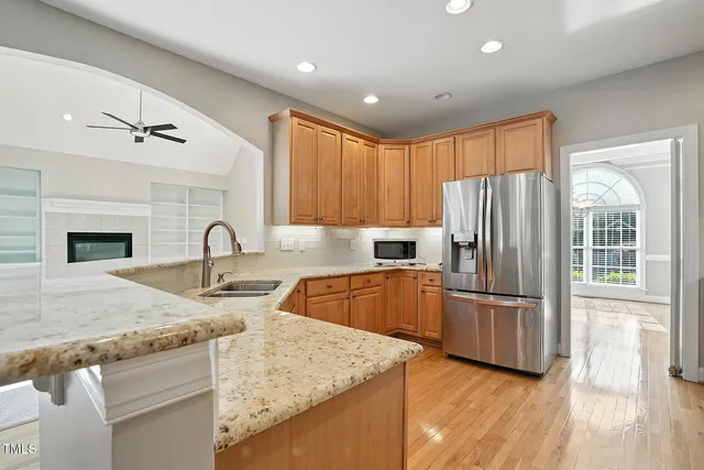 a kitchen with granite countertop a refrigerator and a sink