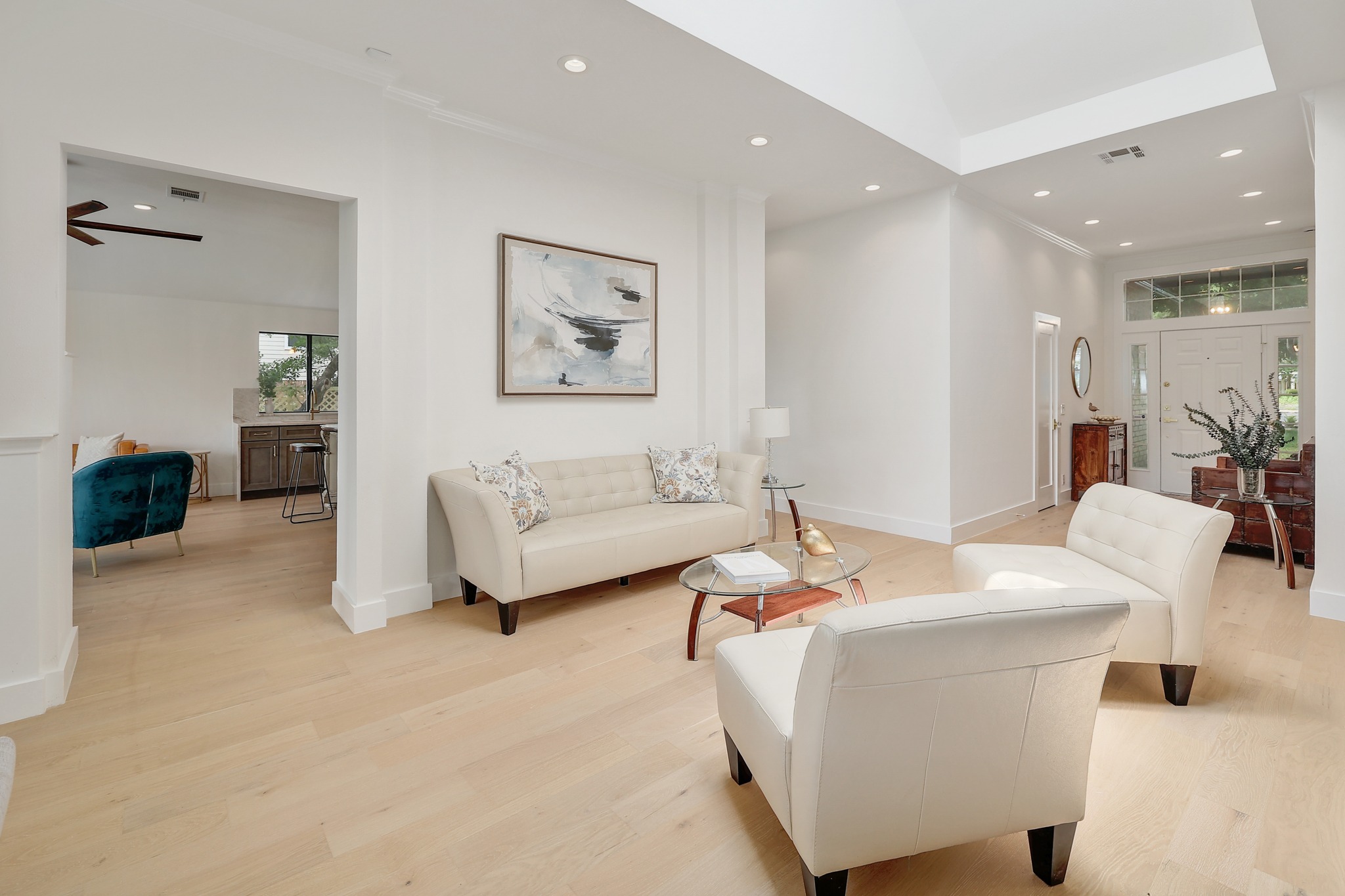7705 Jester Boulevard Austin, TX 78730 - Photo 5 of 36 Sun-filled living space offers light wood flooring, recessed lighting, and an elegant entry.