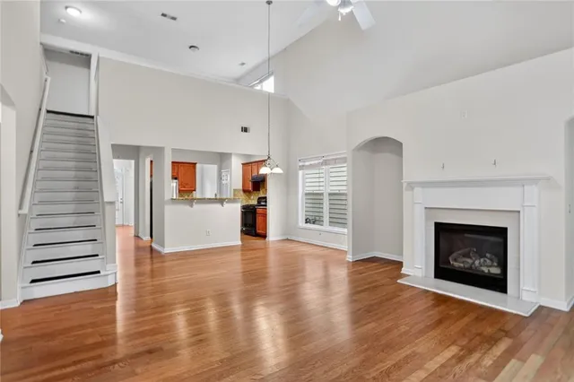a view of a room with wooden floor and fireplace