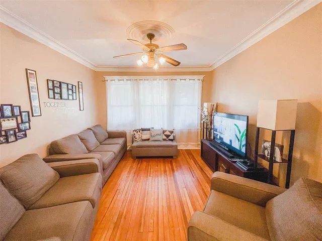 a living room with furniture and a chandelier