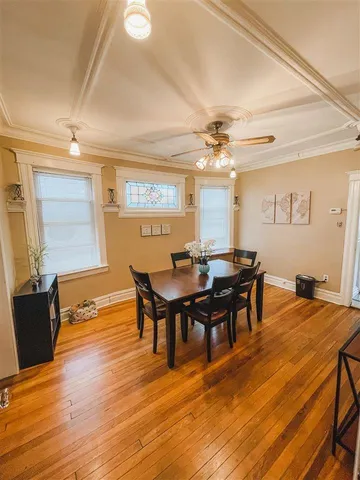 a view of a dining room with furniture and wooden floor