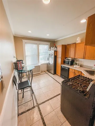 a kitchen with stainless steel appliances granite countertop a stove and a refrigerator