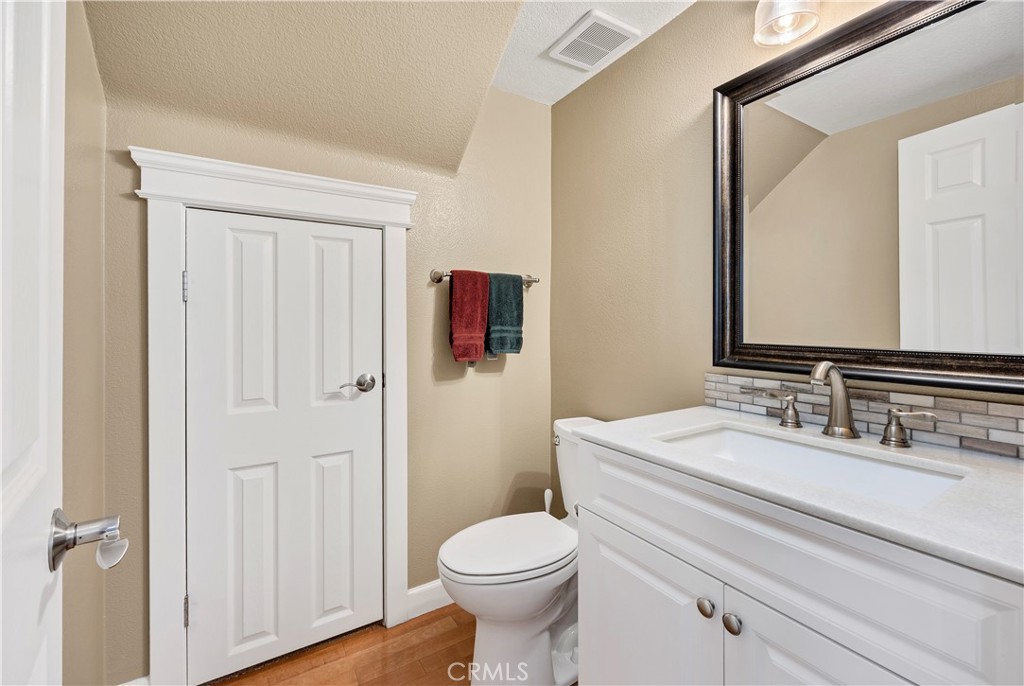 40152 Stowe Road Temecula, CA 92591 - Photo 11 of 56 a bathroom with a sink vanity mirror and toilet