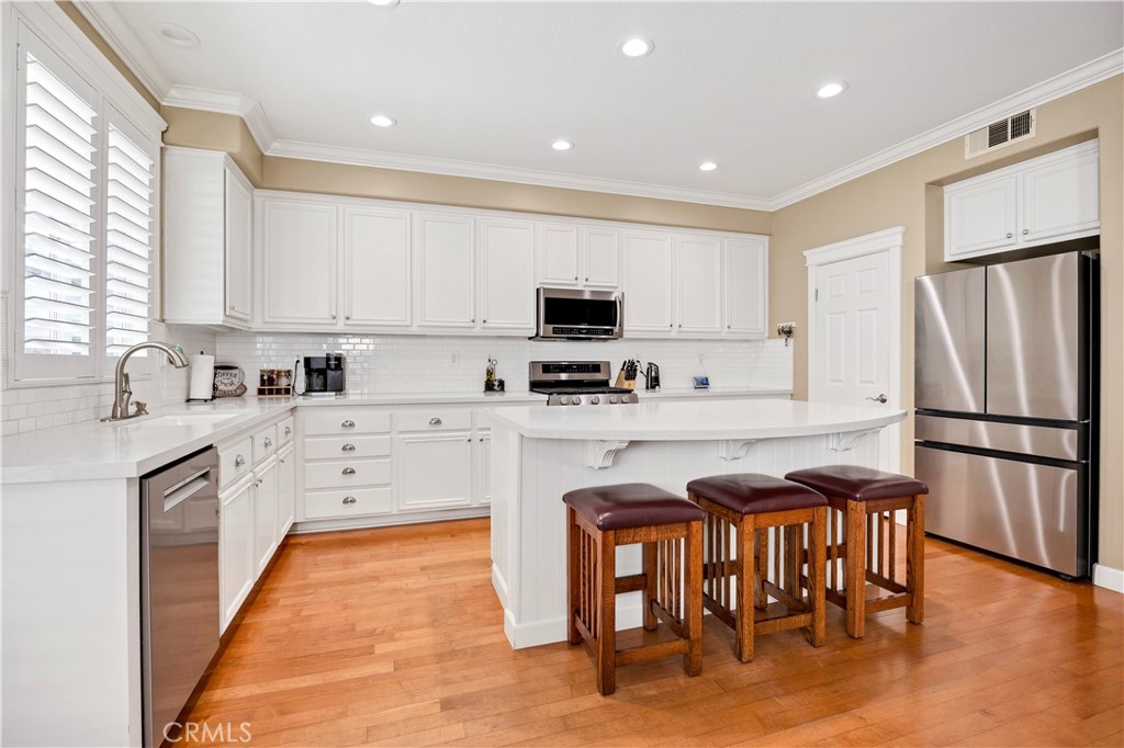 40152 Stowe Road Temecula, CA 92591 - Photo 16 of 56 a kitchen with stainless steel appliances granite countertop a refrigerator stove microwave and sink