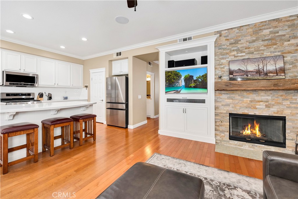 40152 Stowe Road Temecula, CA 92591 - Photo 17 of 56 a living room with stainless steel appliances furniture a fireplace a flat screen tv and a fireplace