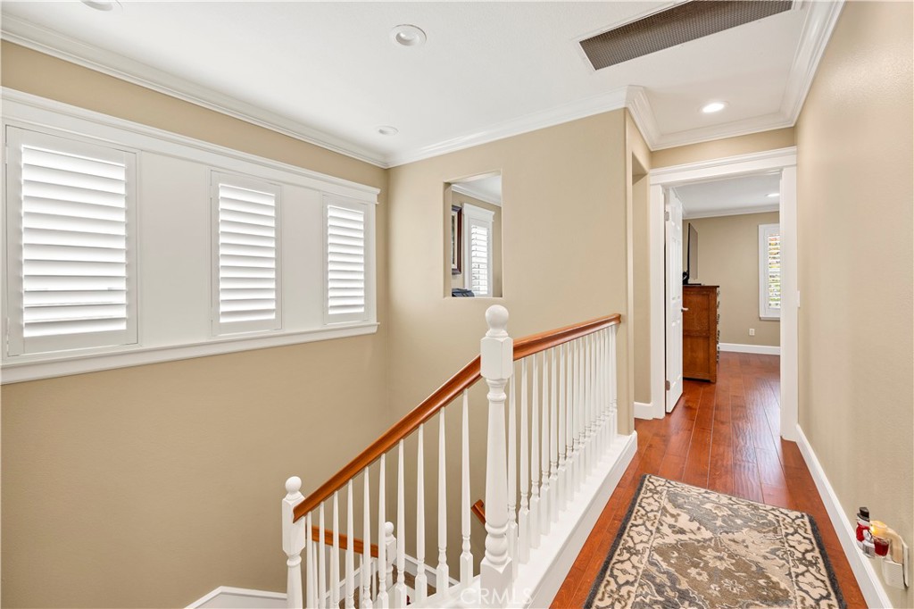 40152 Stowe Road Temecula, CA 92591 - Photo 22 of 56 a view of a hallway with wooden floor and staircase