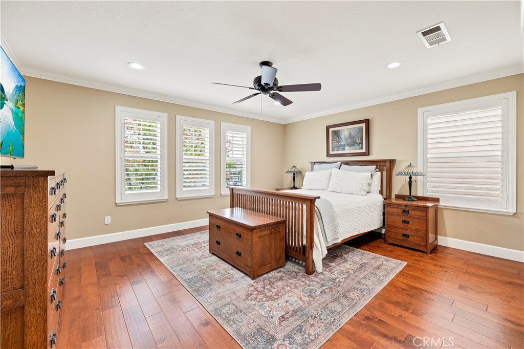 40152 Stowe Road Temecula, CA 92591 - Photo 24 of 56 a spacious bedroom with a bed and wooden floor