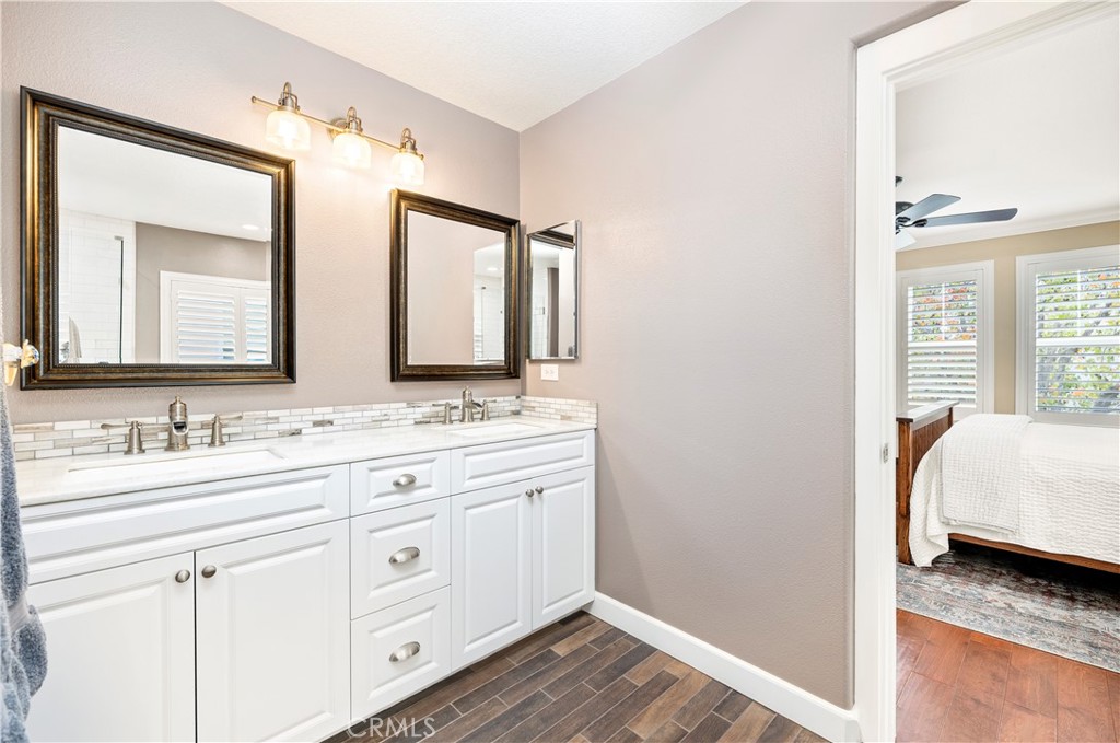 40152 Stowe Road Temecula, CA 92591 - Photo 28 of 56 a en suite bathroom with a double vanity sink and a mirror