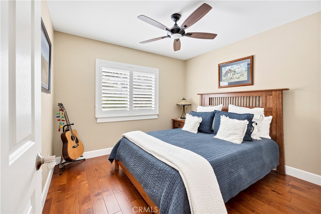 40152 Stowe Road Temecula, CA 92591 - Photo 32 of 56 a bedroom with a large bed and a chandelier