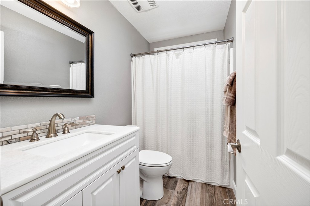 40152 Stowe Road Temecula, CA 92591 - Photo 34 of 56 a bathroom with a sink a toilet and a mirror
