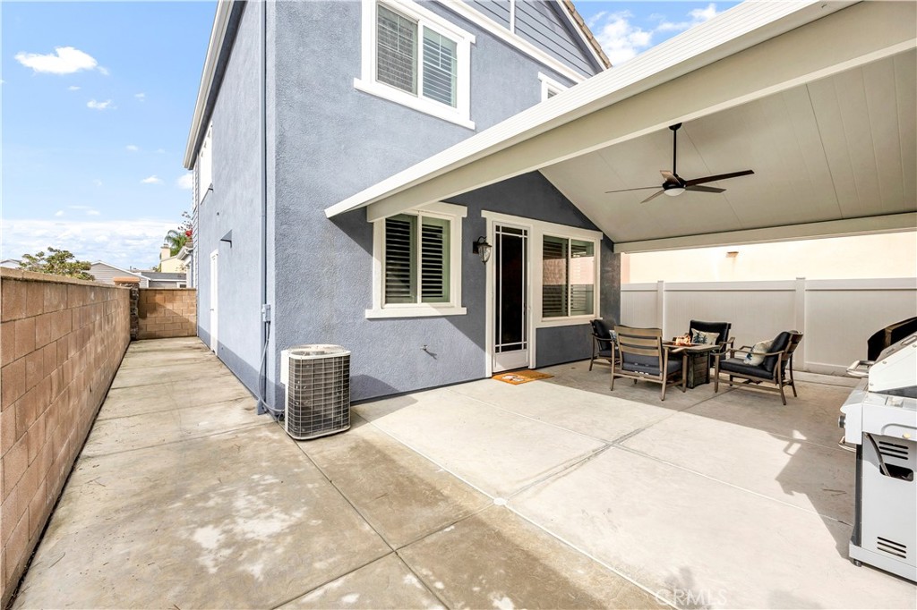 40152 Stowe Road Temecula, CA 92591 - Photo 37 of 56 a view of a patio with table and chairs with wooden floor and fence