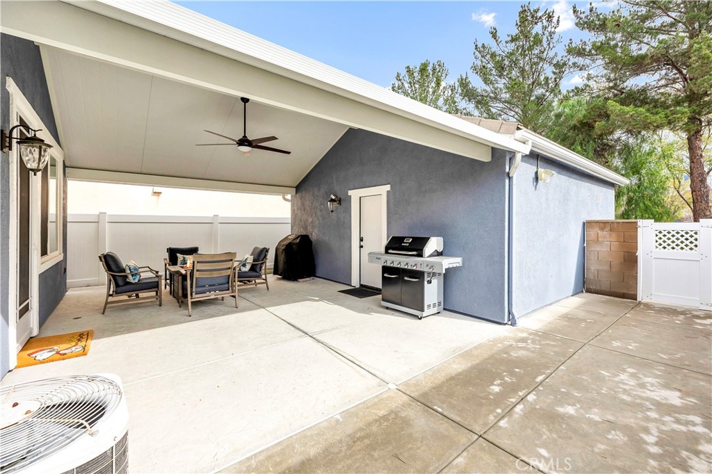 40152 Stowe Road Temecula, CA 92591 - Photo 38 of 56 a view of a patio with table and chairs and couches with wooden floor and fence
