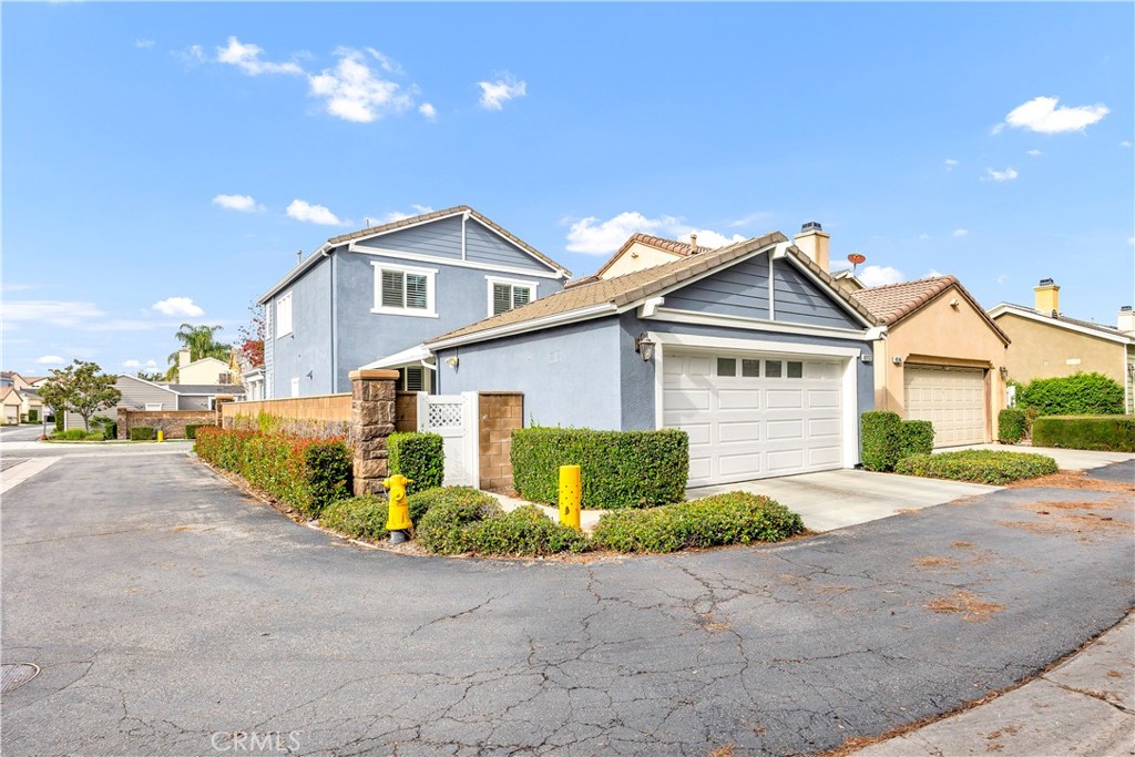 40152 Stowe Road Temecula, CA 92591 - Photo 39 of 56 a front view of a house with a yard and garage