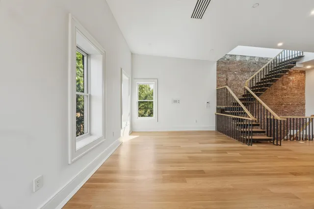 a view of an entryway with wooden floor