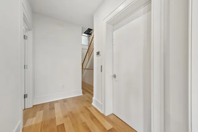a view of hallway with wooden floor