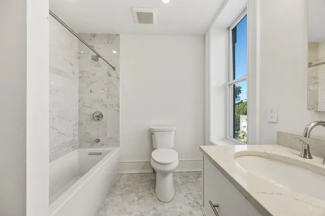 a bathroom with a sink a toilet and a bathtub