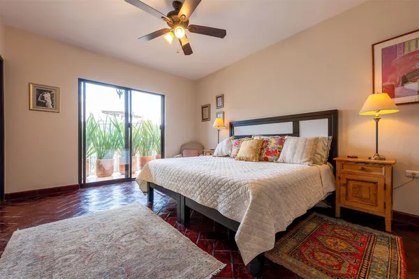 a bed sitting in a bedroom next to a window