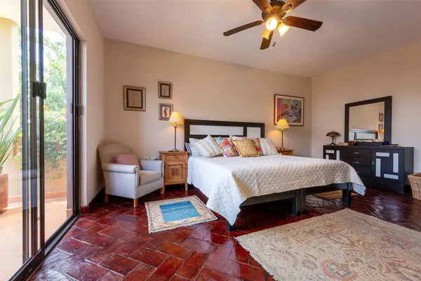 a spacious bedroom with a bed and a chandelier