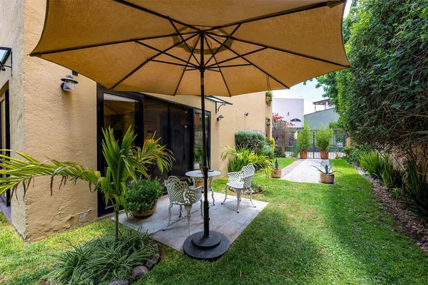 a view of table and chairs under an umbrella