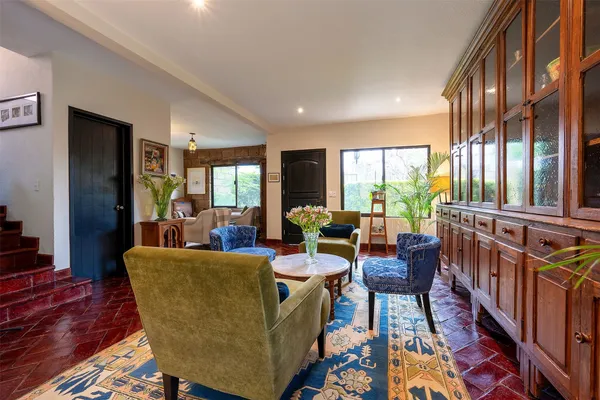 a living room with furniture fireplace and a large window