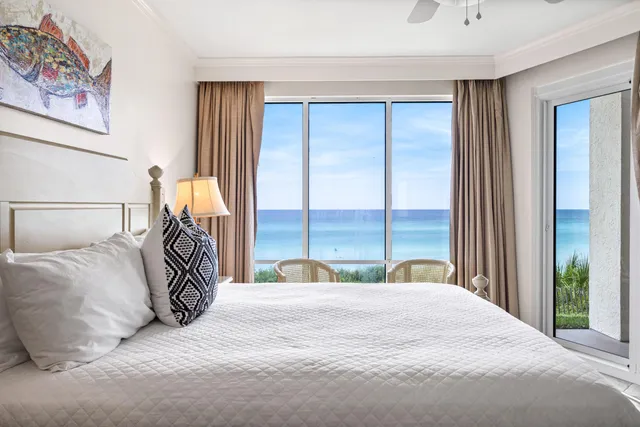 a bedroom with a large bed and a large window