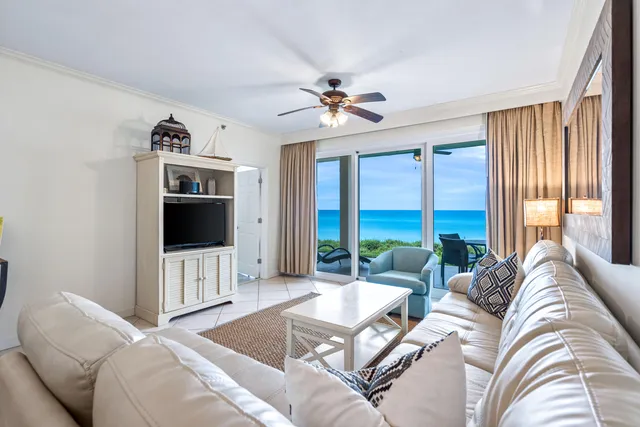 a living room with furniture a large window and a flat screen tv