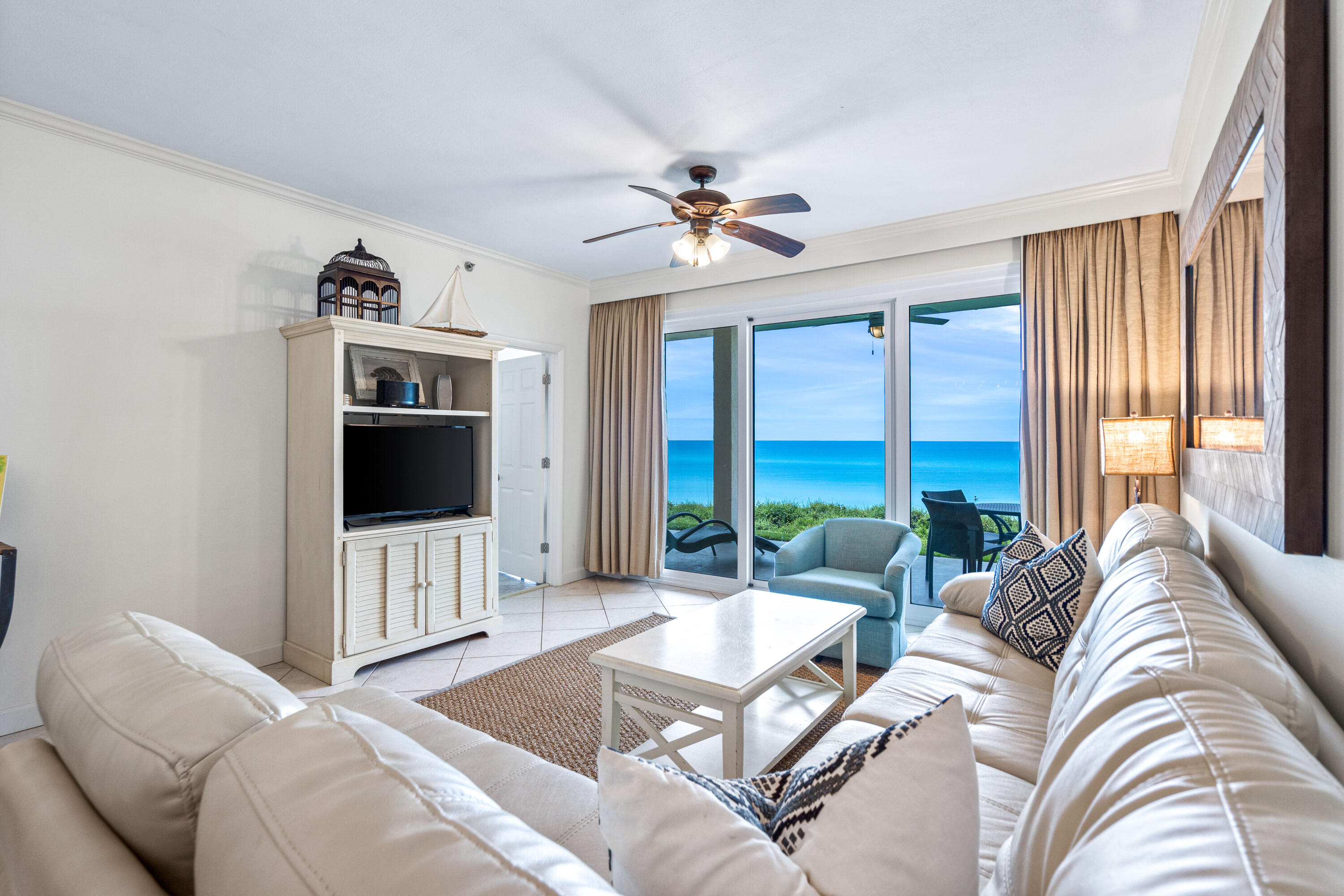 10254 East Co Highway, Unit 12W Inlet Beach, FL 32461 - Photo 11 of 42 a living room with furniture a large window and a flat screen tv