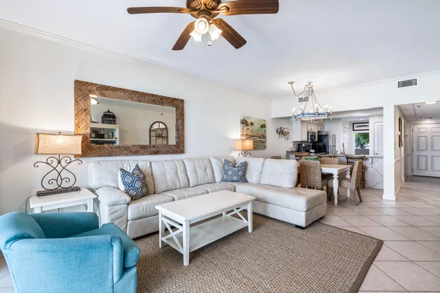 a living room with furniture and a chandelier
