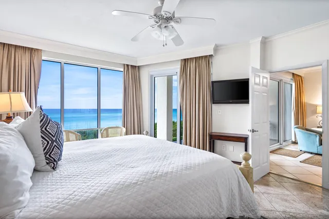 a bedroom with a large bed and a large window