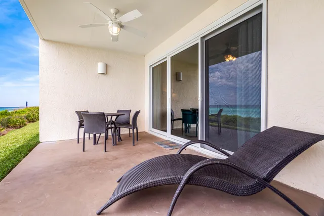 a balcony with a table and chairs