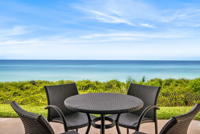 a view of a patio with furniture and a yard