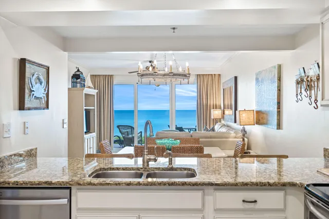 a kitchen with granite countertop a stove and cabinets