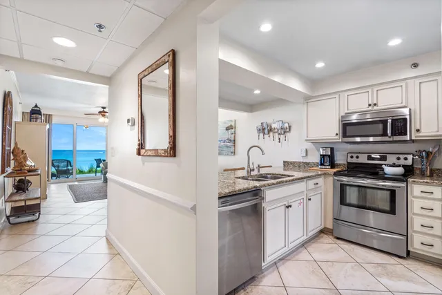 a kitchen with stainless steel appliances a stove sink and microwave