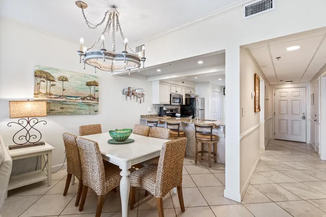 a view of a dining room with furniture and chandelier
