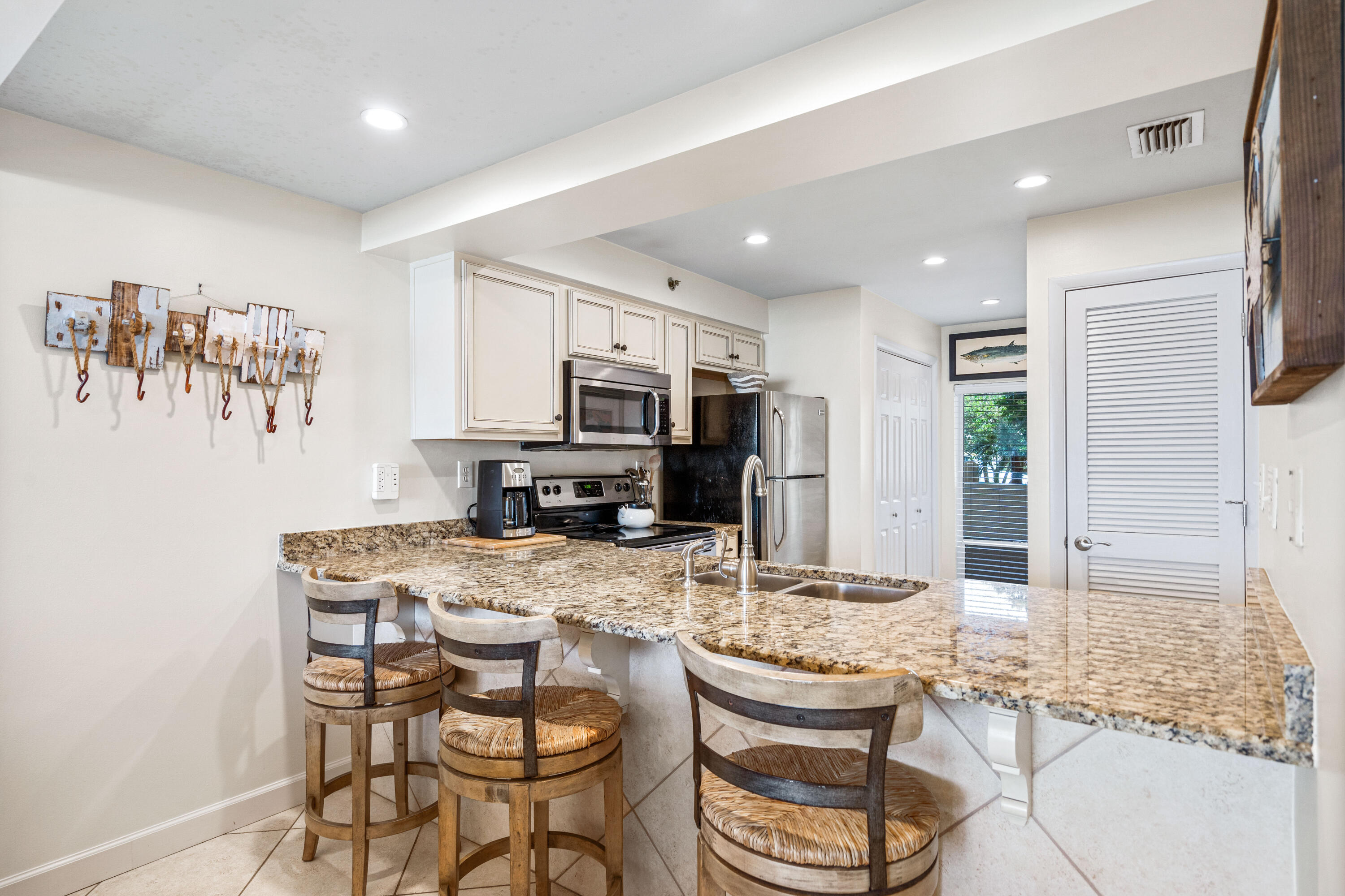 10254 East Co Highway, Unit 12W Inlet Beach, FL 32461 - Photo 8 of 42 a kitchen with kitchen island granite countertop a sink and cabinets