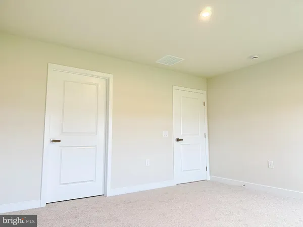 an empty room with closet area