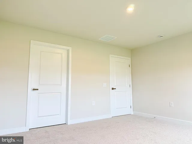 an empty room with closet area