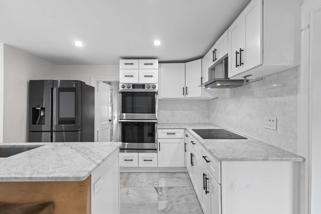7 Darrow Street Worcester, MA 01606 - Photo 12 of 42 a kitchen with stainless steel appliances granite countertop a sink stove and refrigerator