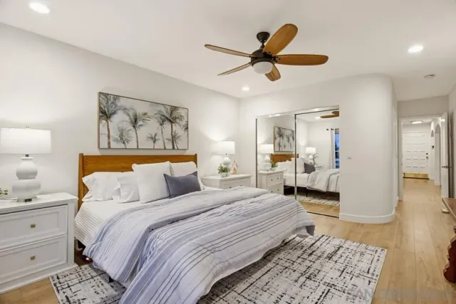 a bedroom with a balcony a bed and a chandelier