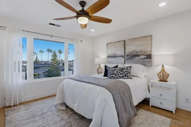 a view of a patio with couches table and chairs and potted plants